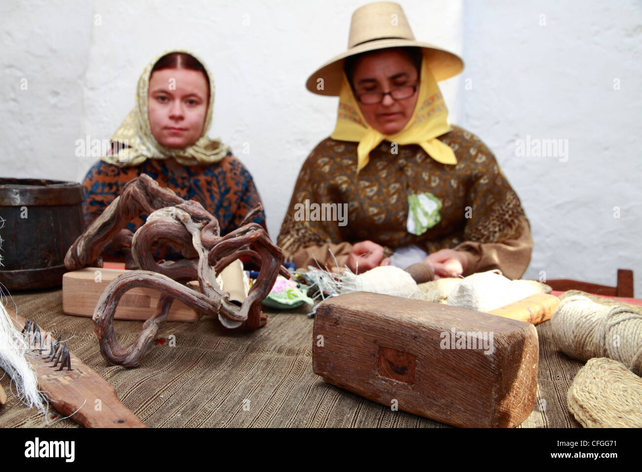 Women in traditional costume making "Espardenyes", the traditional sandals at a handicraft fair, Ibiza, Spain Stock Photo