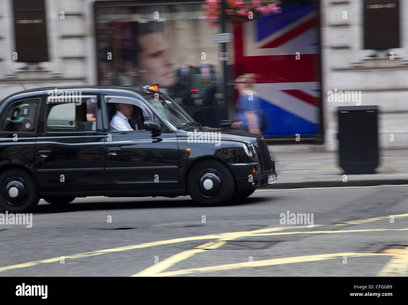 Iconic London black taxi cab and union jack flag Stock Photo