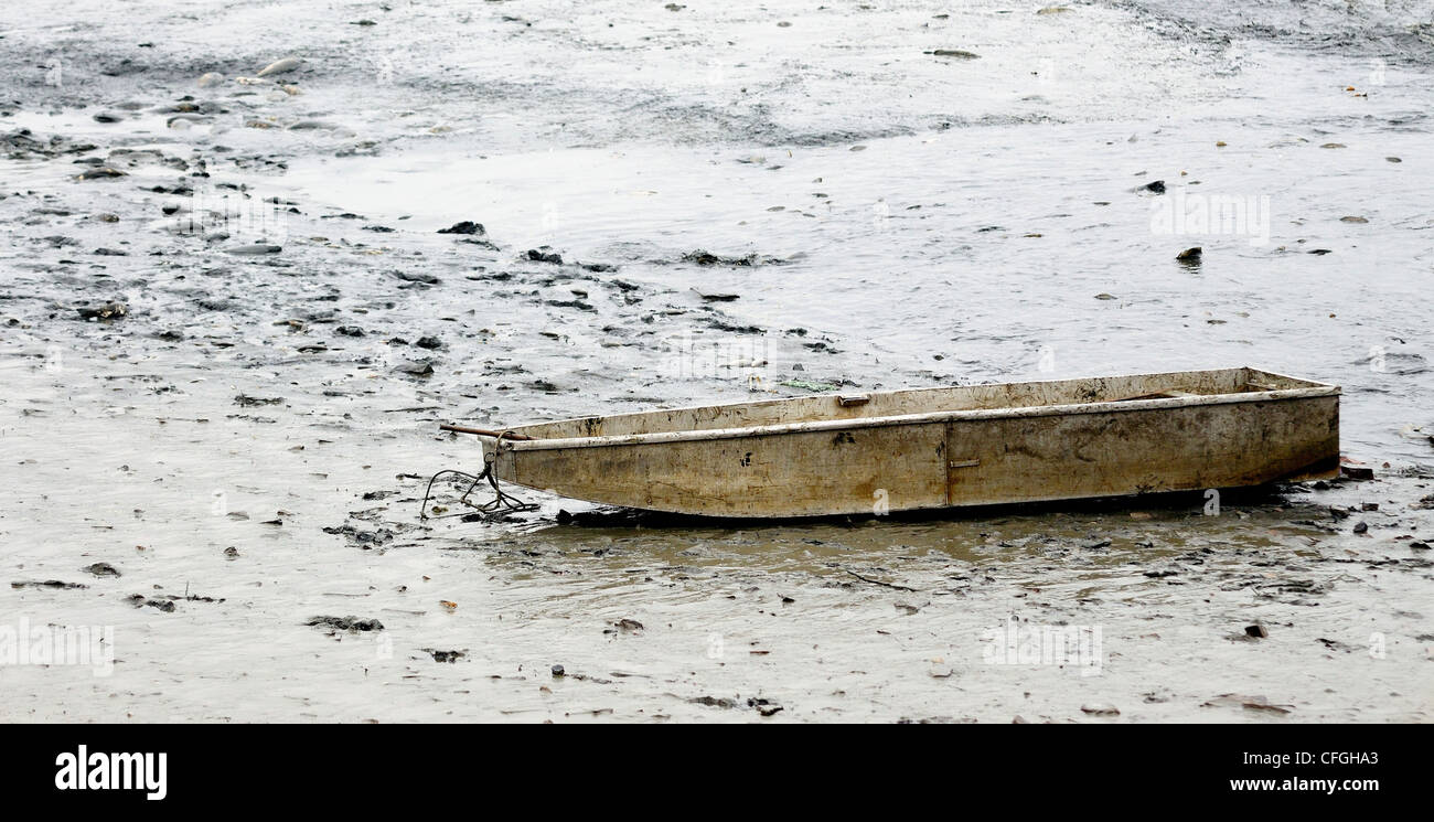 View to the old dirty fishing boat in drained pond. Stock Photo