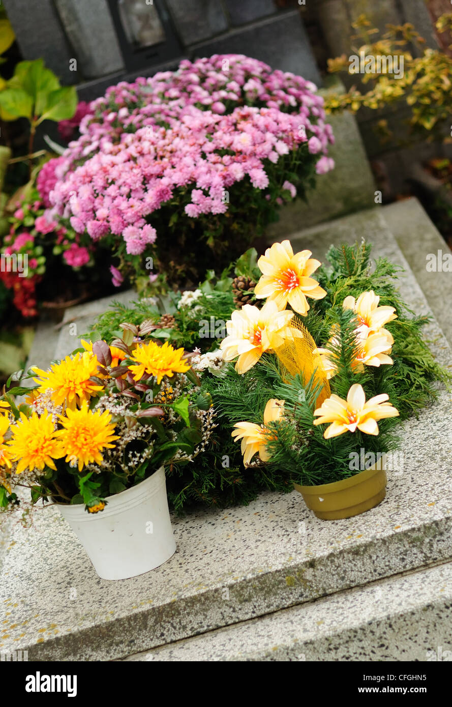 Funeral flowers placed on the grave at All souls holiday Stock Photo