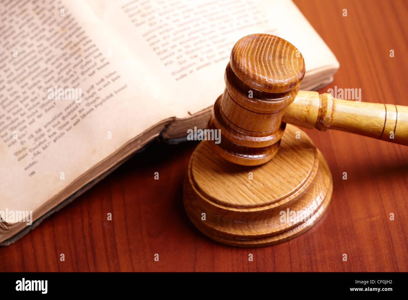 Old book and gavel on wooden desk Stock Photo