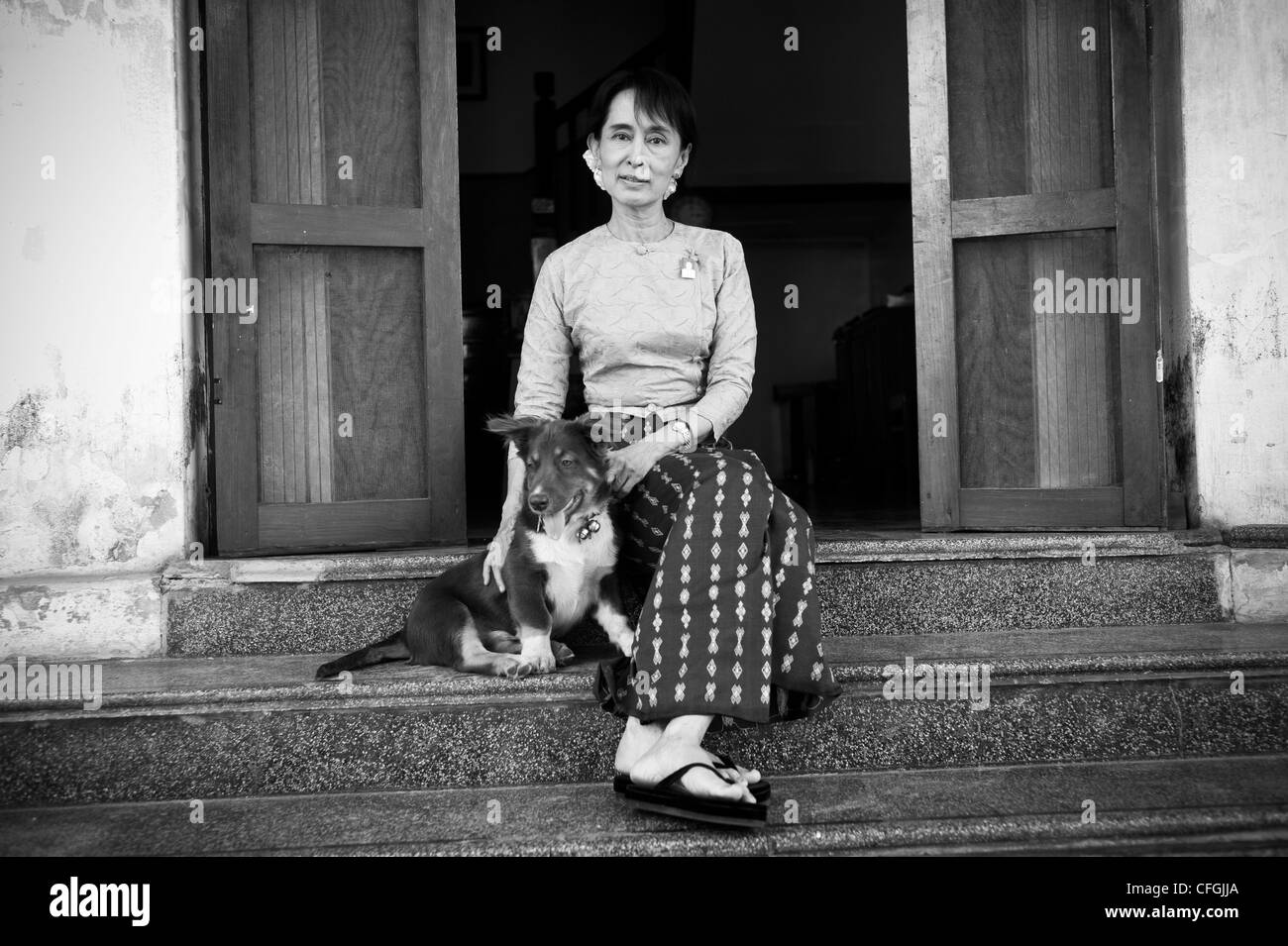 Aung San Suu Kyi, State Chancellor of Myanmar's Government and the leader of the National League for Democracy Party (NLD) at her home in Yangon Myanmar, Burma. She is with her pet dog Tai Chi Toe who was a gift to her from her son Kim Aris Stock Photo