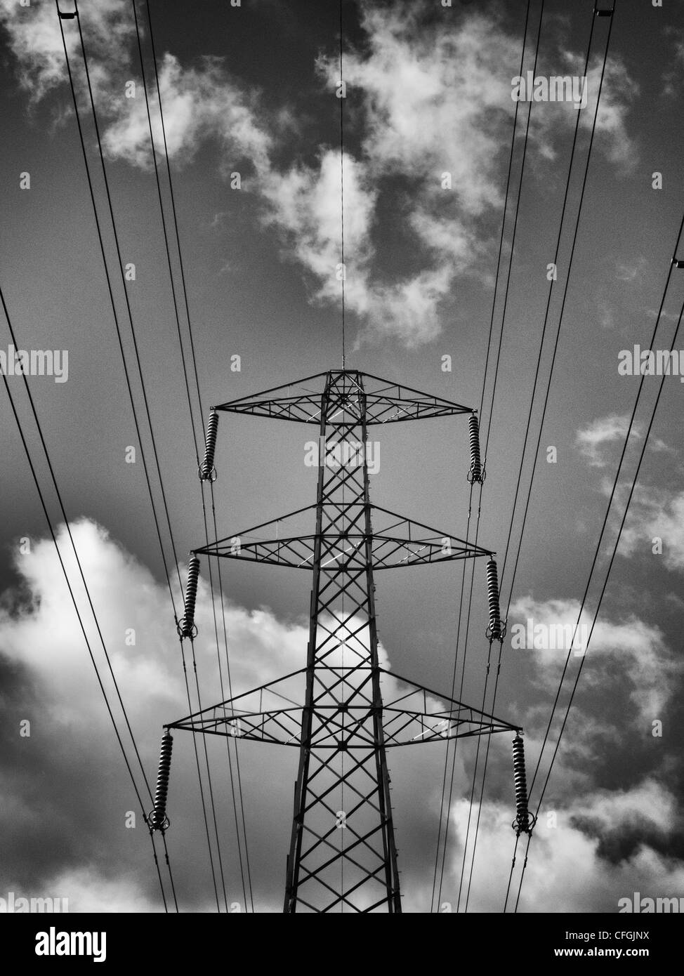 An electricity pylon against a cloudy sky Stock Photo - Alamy