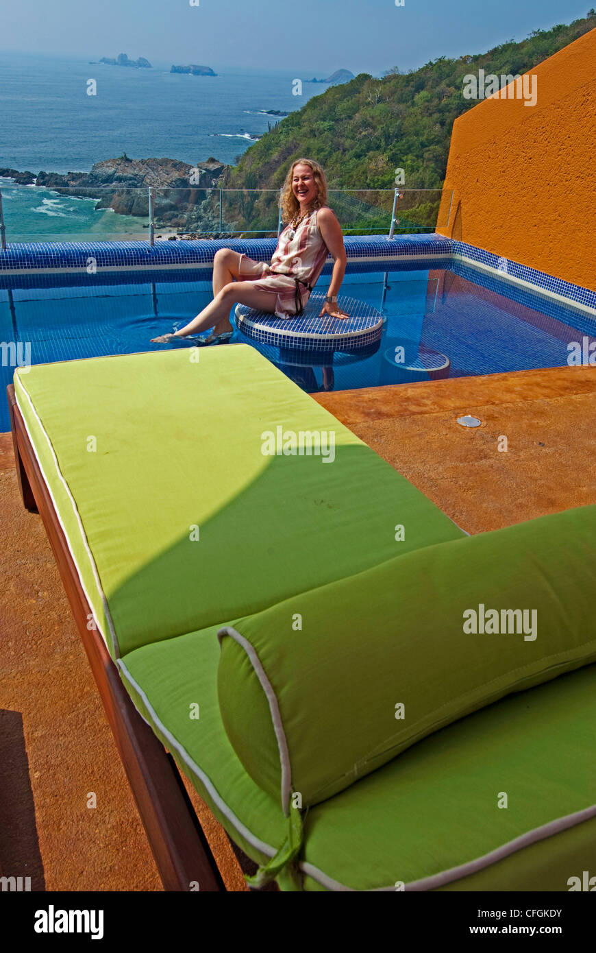 A young woman in a Las Brisas Ixtapa resort's deluxe room outdoor patio pool in Ixtapa, Mexico Stock Photo