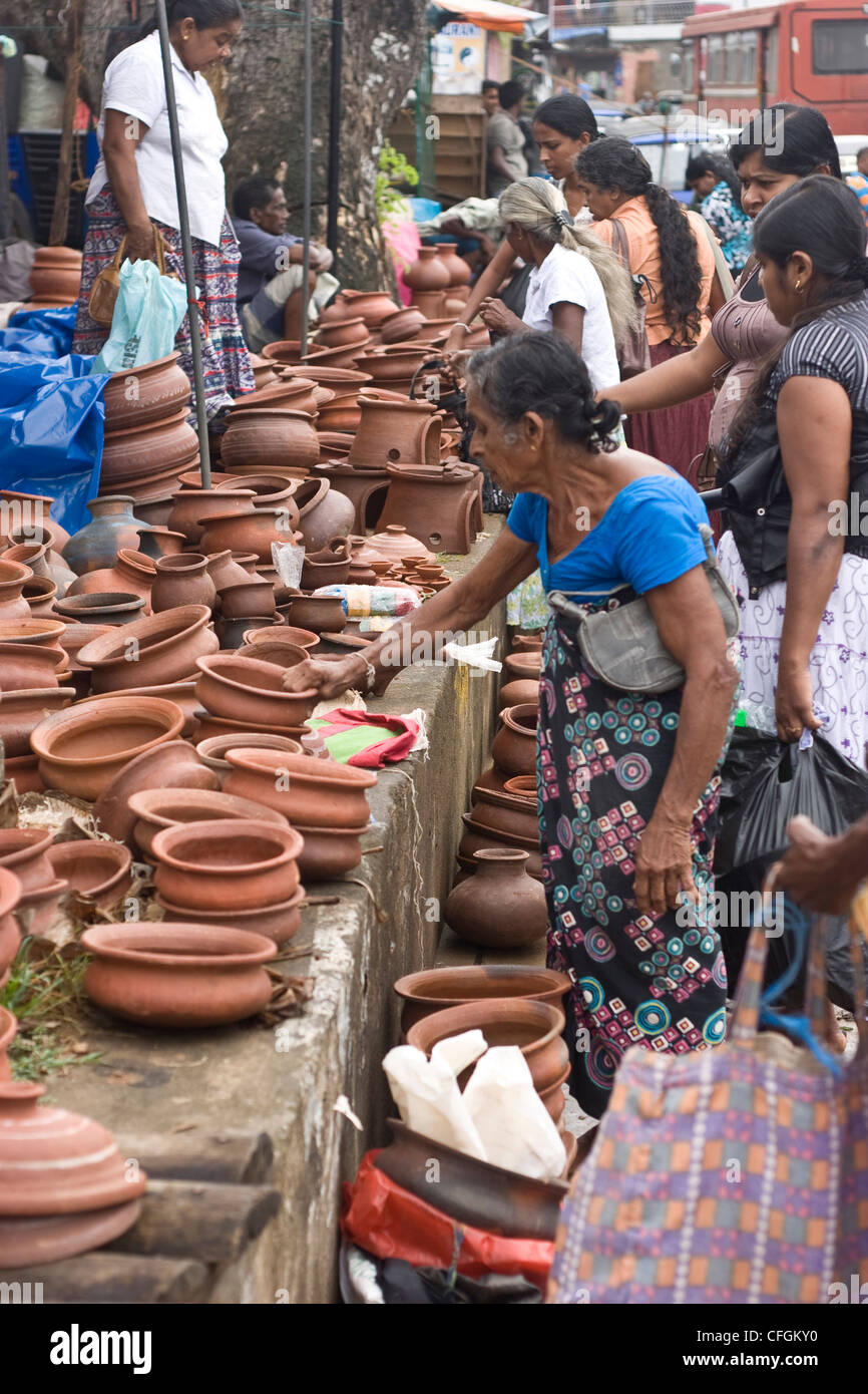 Women choosing clay post in market Stock Photo - Alamy