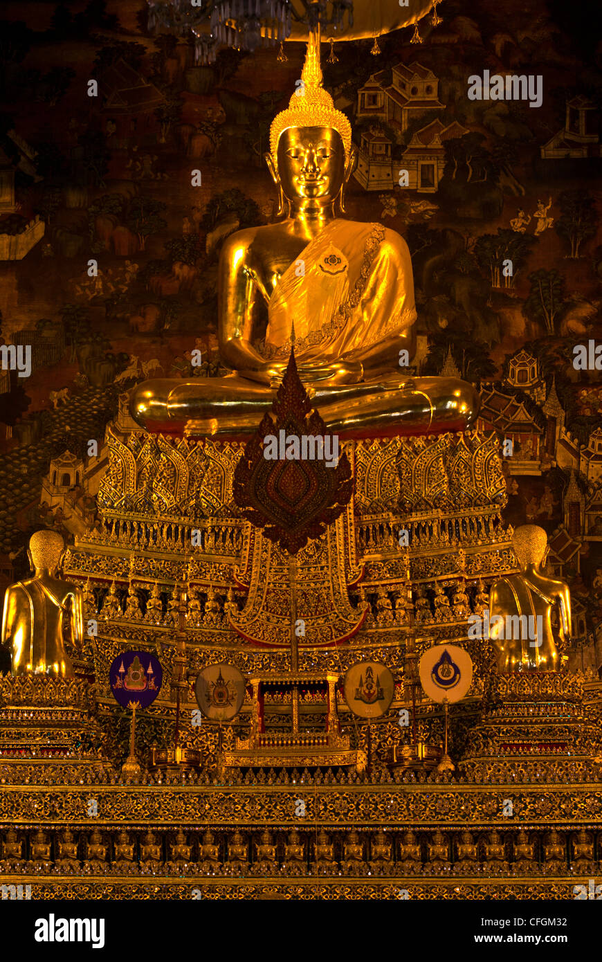 An enormous golden gilded statue of the Buddha seated in the Ubosot. Stock Photo