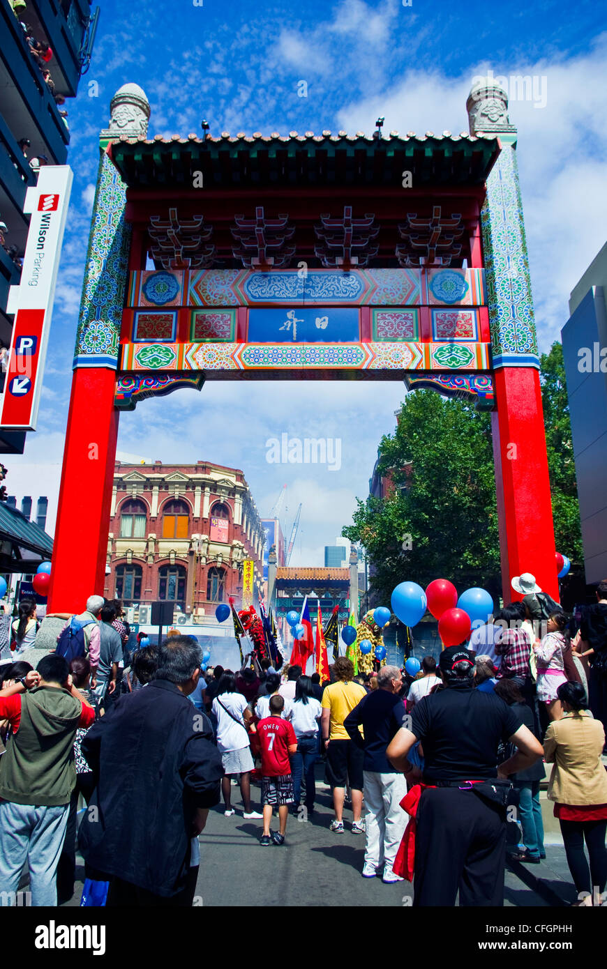 Crowds gather to celebrate Chinese New Year with fireworks and flags. Stock Photo