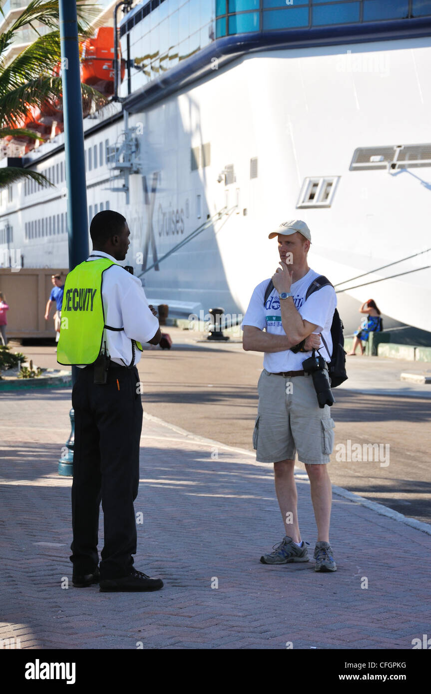 Port in Nassau, Bahamas tourist talking with security officer Stock
