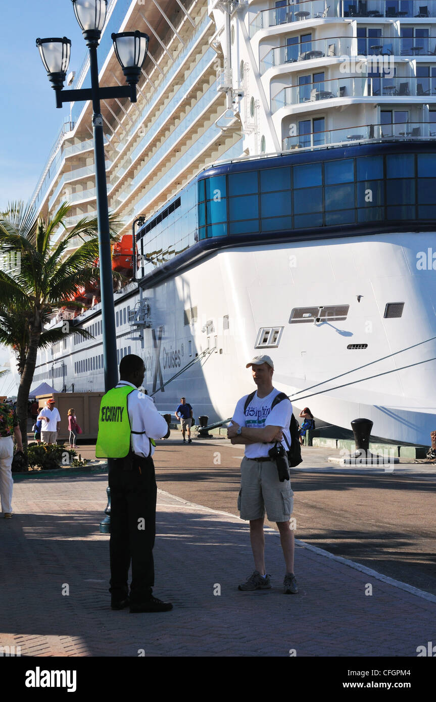 Port in Nassau, Bahamas tourist talking with security officer Stock