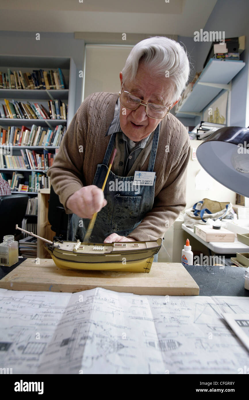 A man working on a sailing ship model Stock Photo