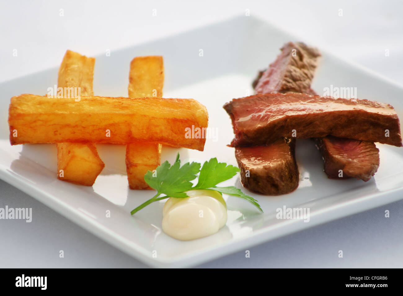 Steak and chips with parsley and mayonnaise Stock Photo