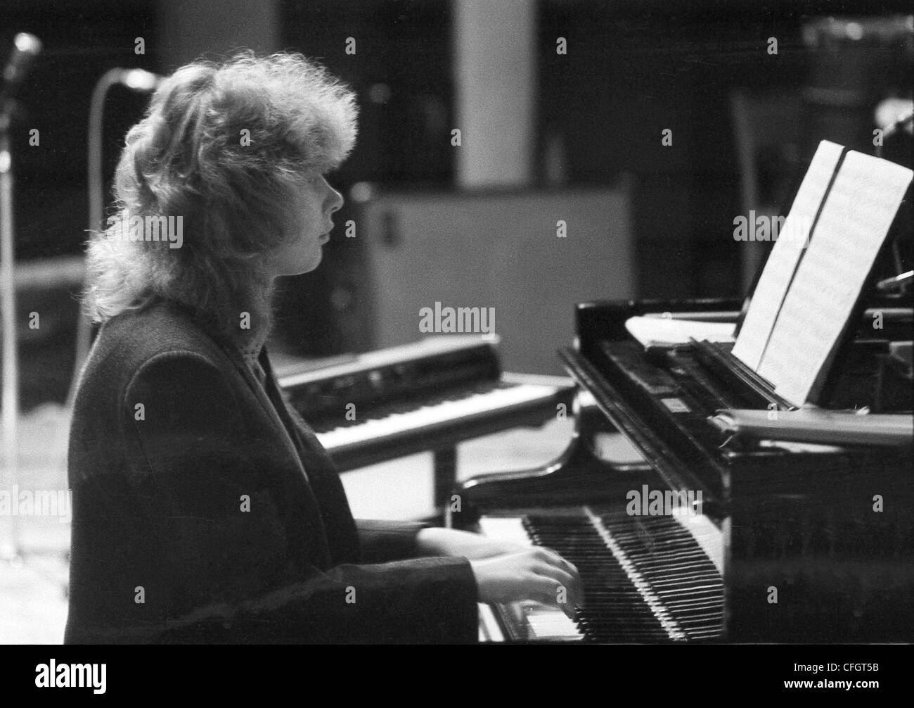A man plays the piano (Film scan, very grainy image) Stock Photo
