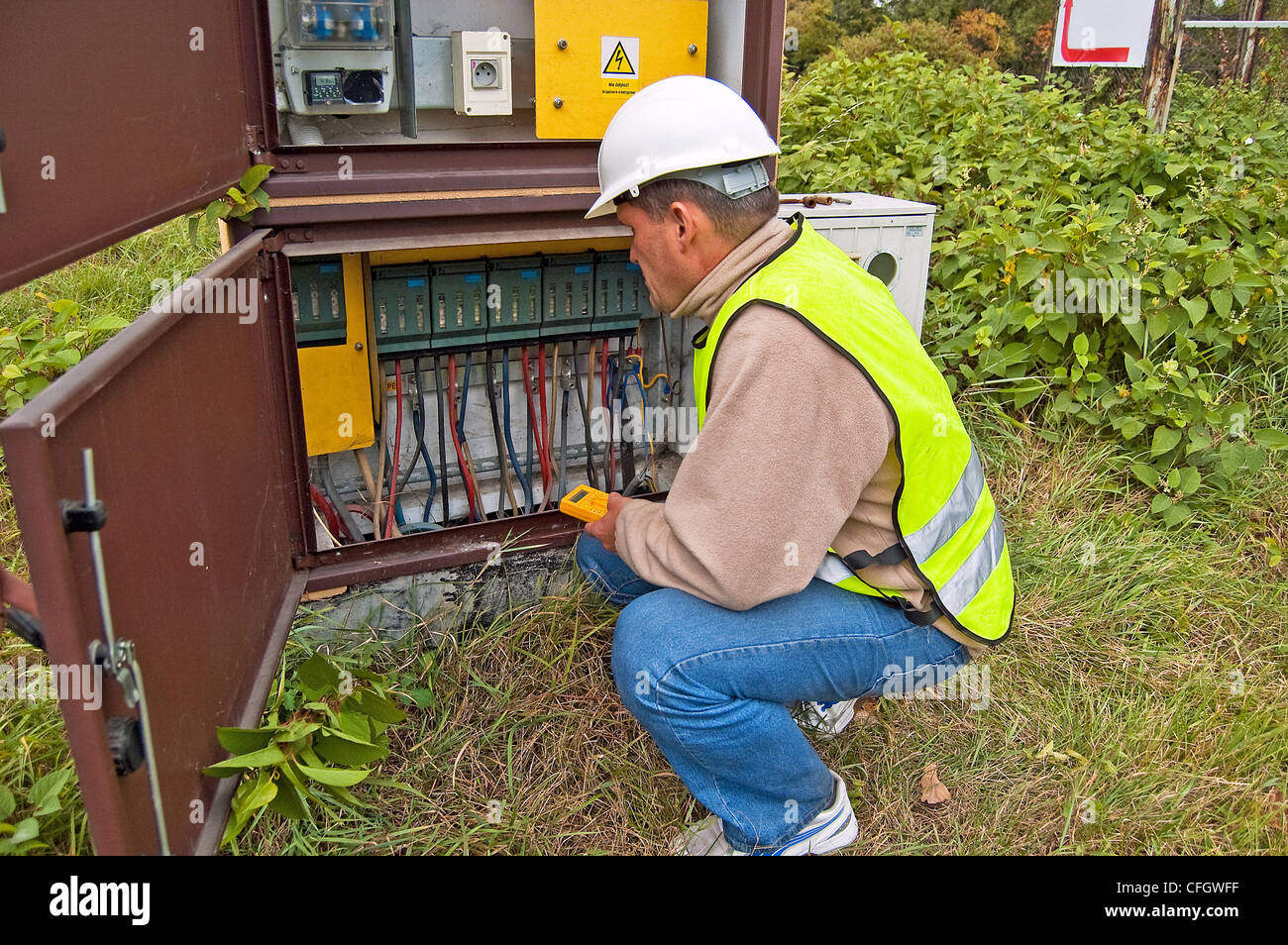 Electrician checking the condition of wiring and electricity meters for ...