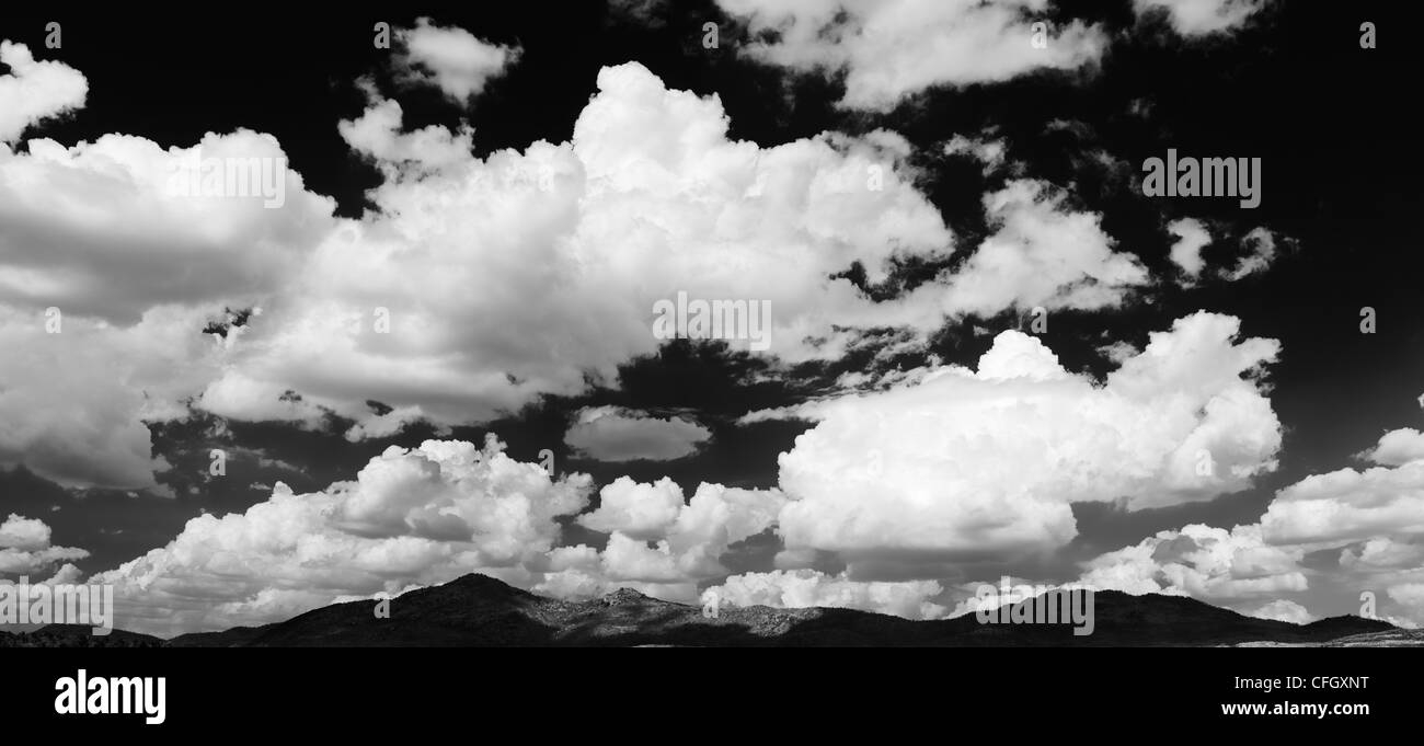 Altocumulus undulatus and cumulus clouds. Cloud sky panoramic. India. Monochrome Stock Photo