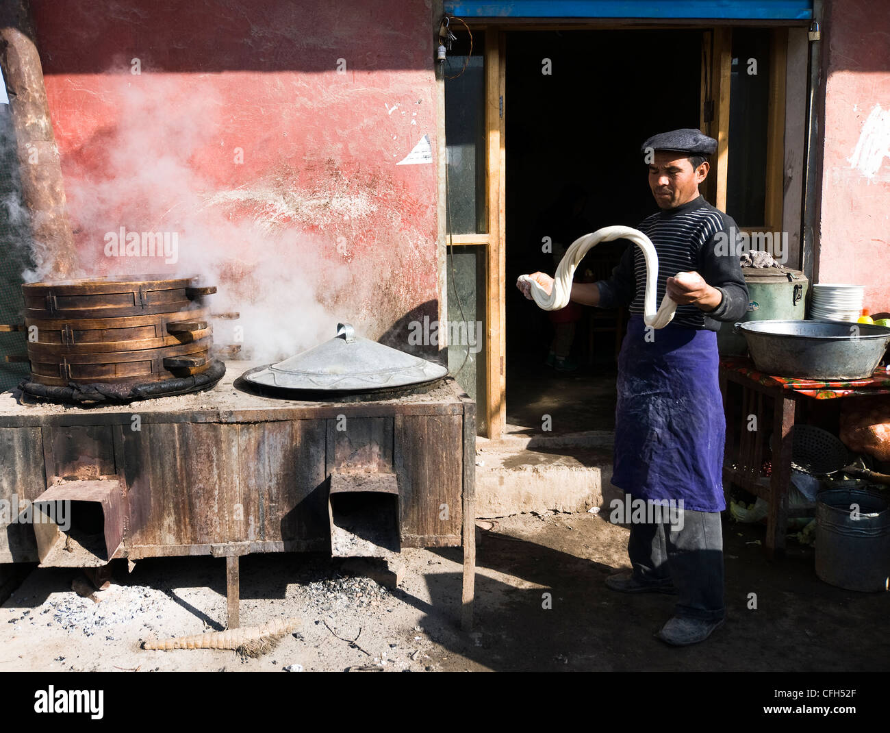 Hand Pulled Noodles ( Lamien or Lagman ) being prepared by a cook in a small street restaurant in Xinjiang, China. Stock Photo