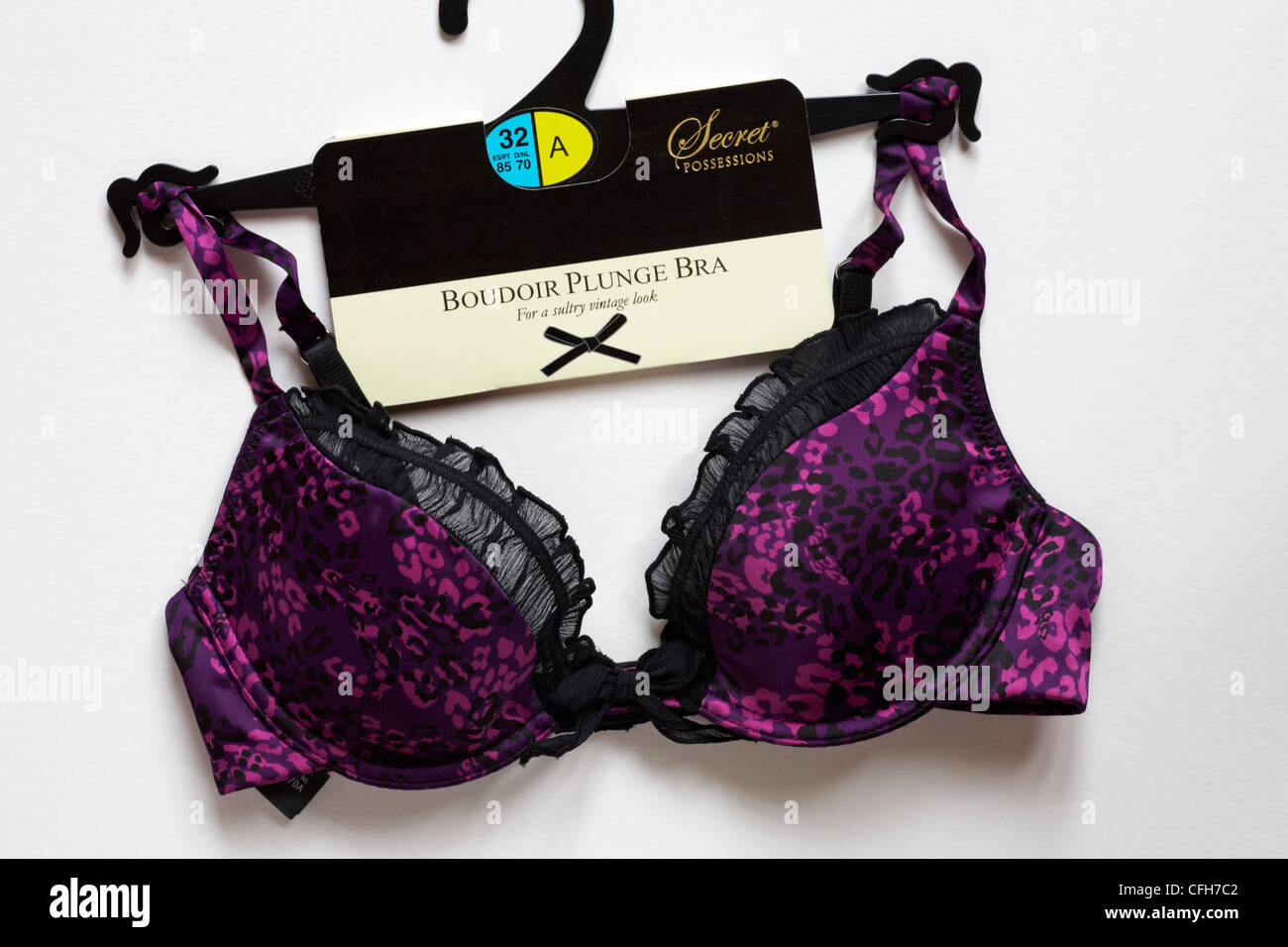 purple and black Secret Possessions Boudoir Plunge Bra for a sultry vintage  look on hanger isolated on white background Stock Photo - Alamy