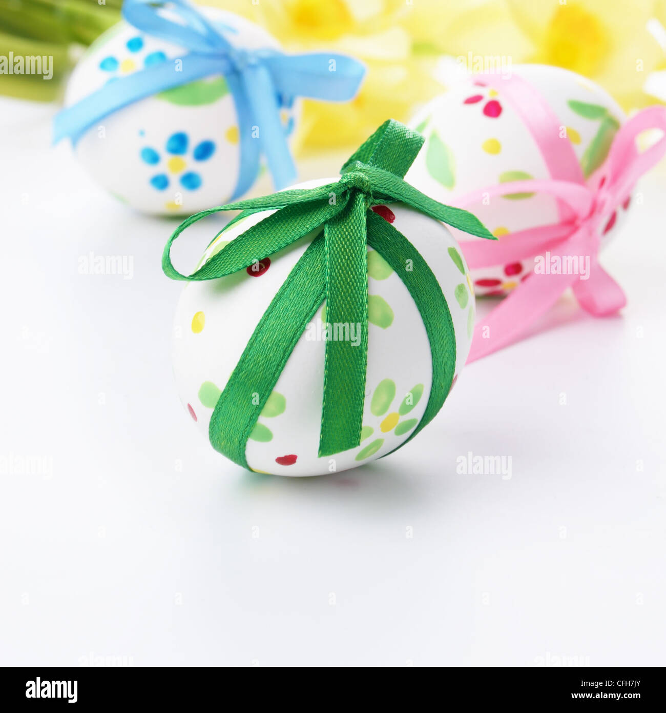 Easter eggs with bows over floral background Stock Photo - Alamy