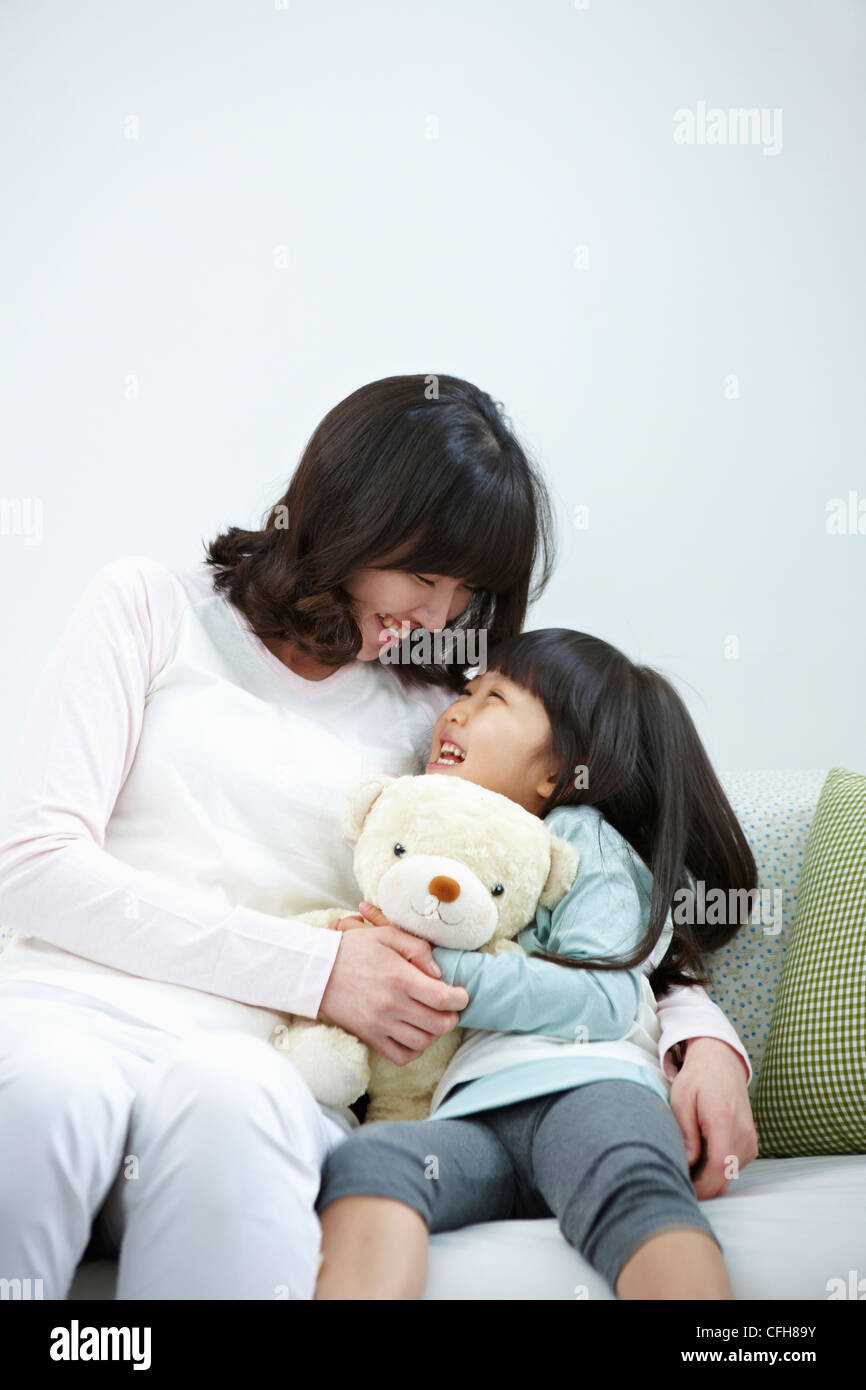 The woman and girl smiling at each other Stock Photo
