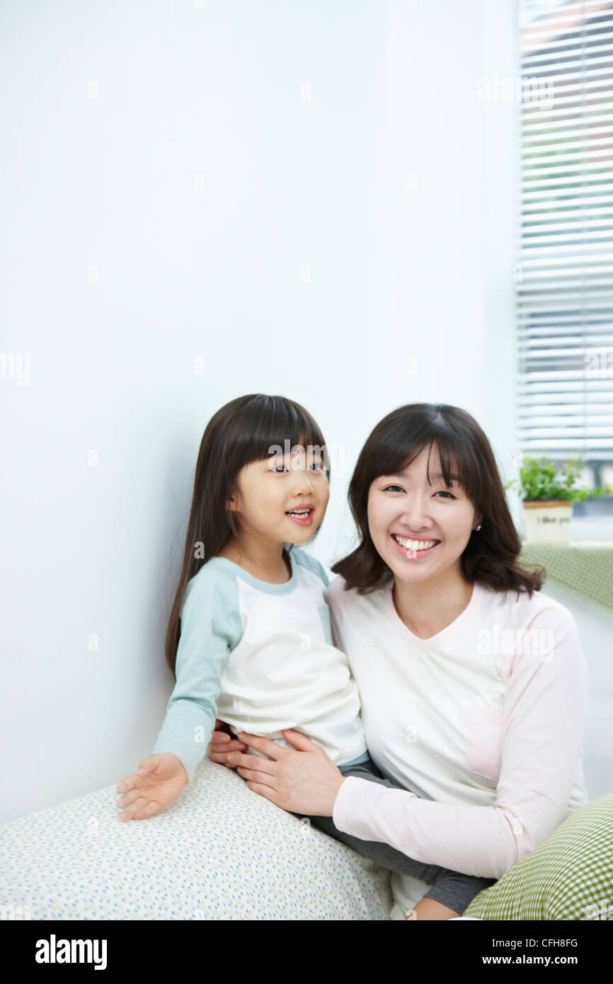 The woman hugging the girl with big smile Stock Photo - Alamy