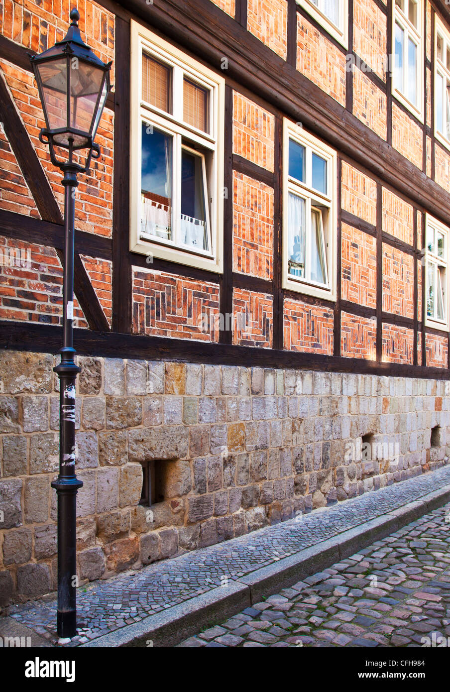 The facade of a half-timbered medieval house in a cobbled street in the UNESCO World Heritage town of Quedlinburg, Germany. Stock Photo