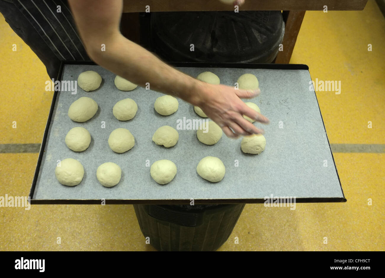 An artisan baker producing bread and buns Stock Photo