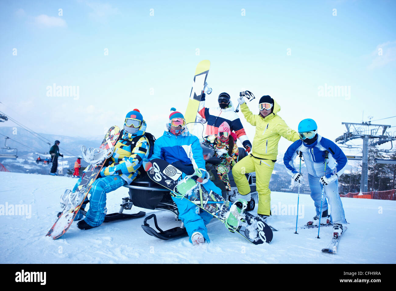 The people wearing the ski and snowboarding gear in the ski resort