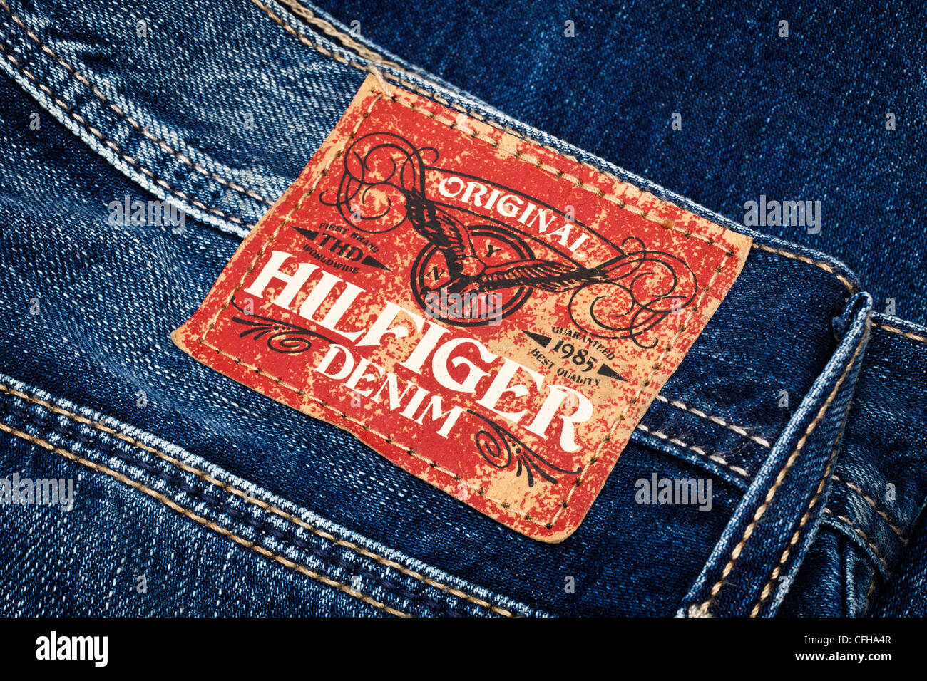 Tommy Hilfiger clothing brand logo on pair of mens denim jeans Stock Photo