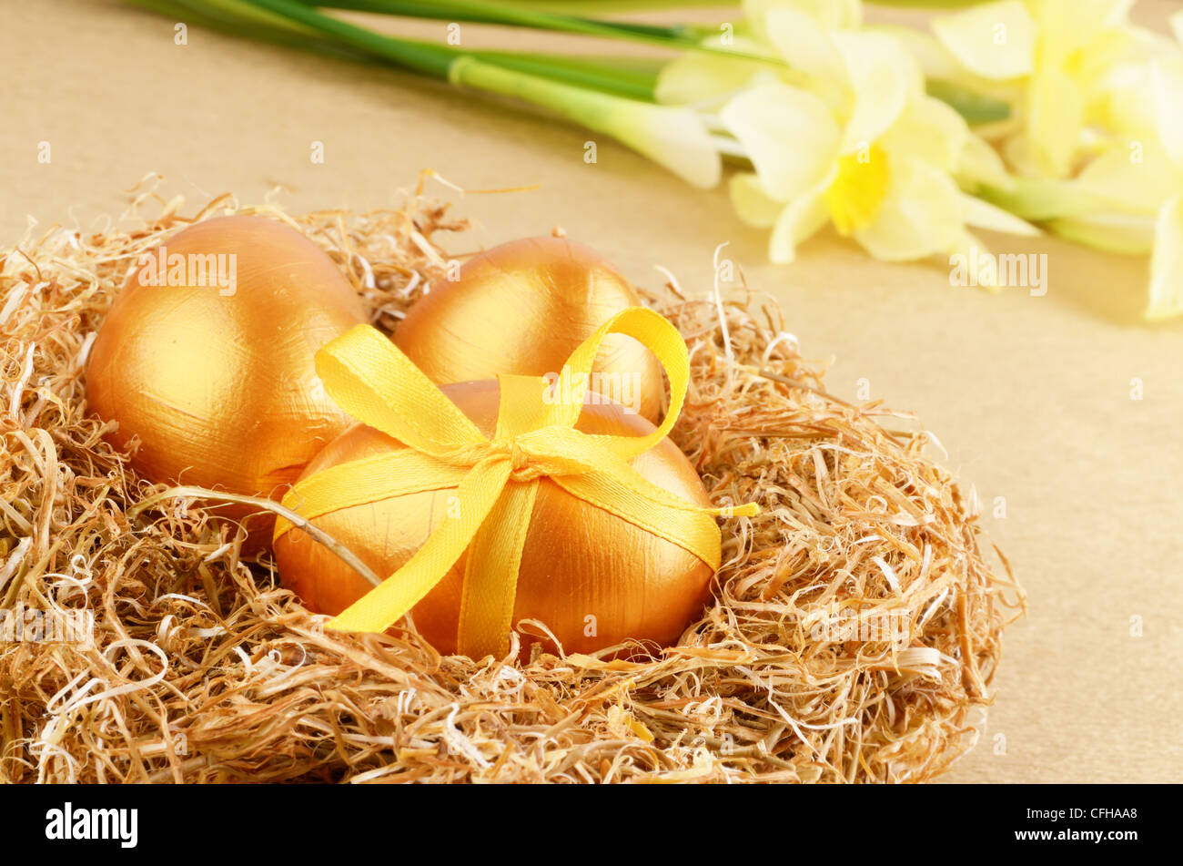 Golden Easter eggs in the nest over gold background Stock Photo - Alamy