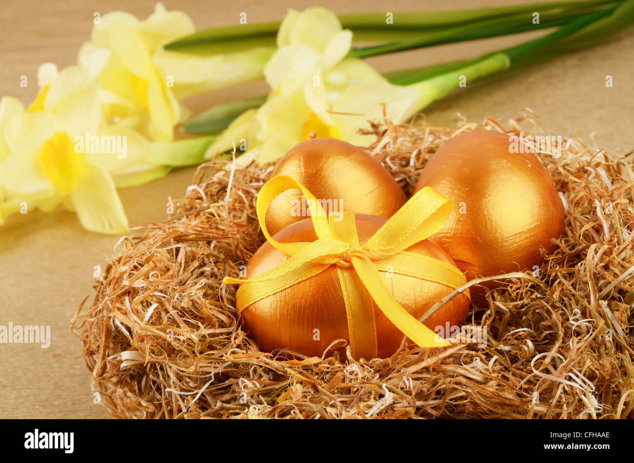 Golden Easter eggs in the nest over gold background Stock Photo - Alamy