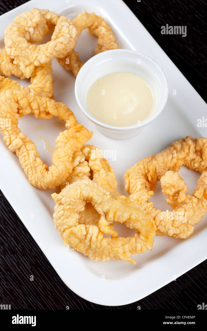 Deepfried squid with sauce at white plate Stock Photo Alamy