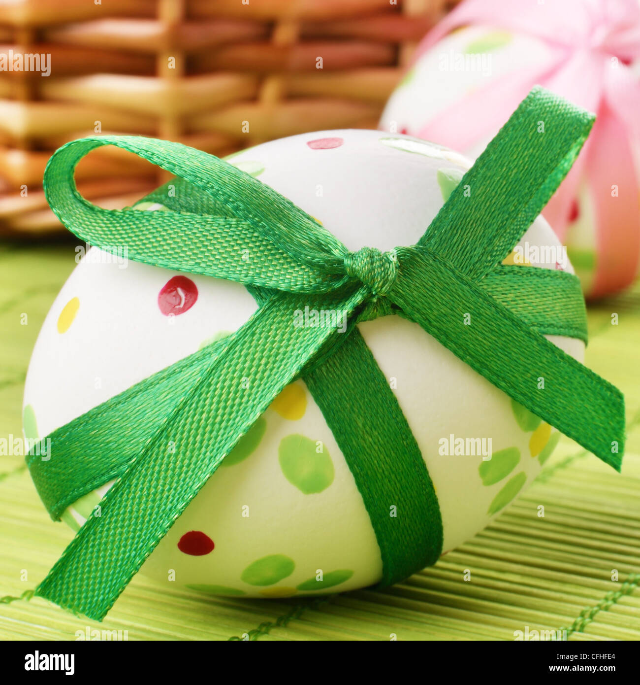 Easter eggs with bows over green background Stock Photo - Alamy