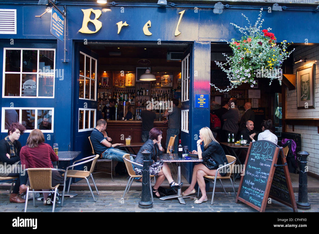 Customers and patrons sit outside of the bar Brel in the West End of Glasgows Byers road, a popular place to out at night. Stock Photo