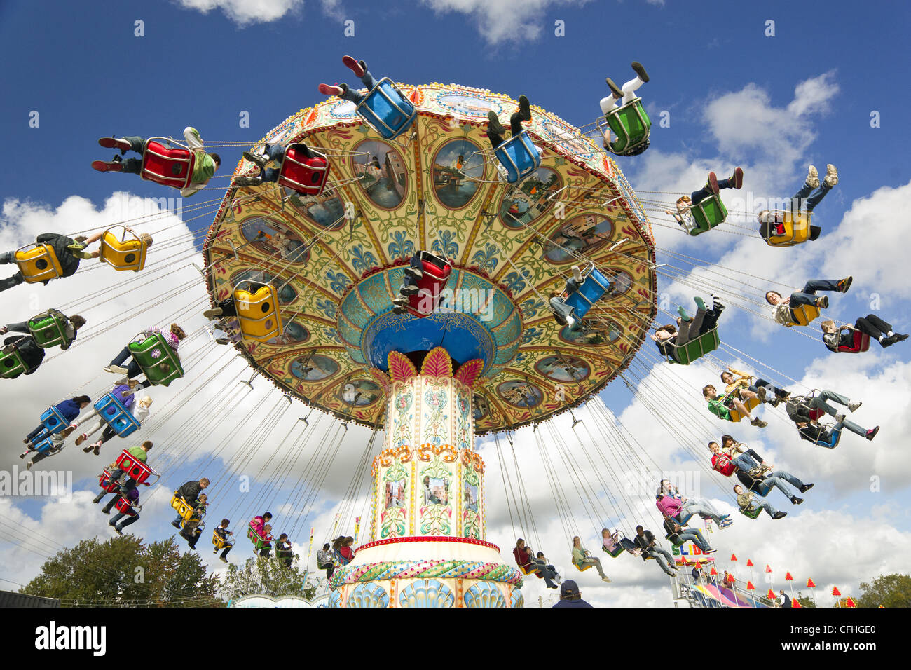 Families enjoying an amusement park ride at a carnival Stock Photo