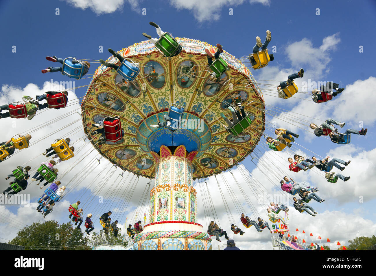 Families enjoying an amusement park ride at a carnival Stock Photo