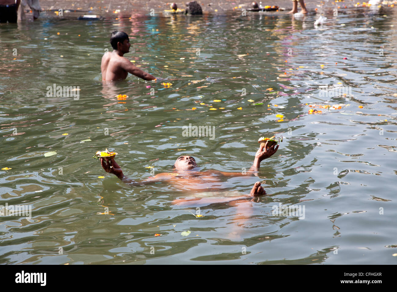 Man bathing in the sacred waters of the Godavari river. Ram Kund. Nasik. India Stock Photo