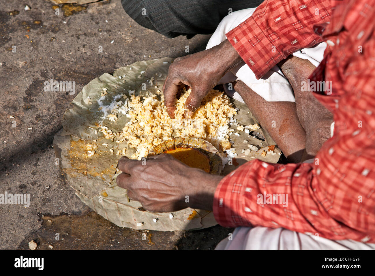 Man eating a thali (traditional indian meal) with his hand. Nasik. Maharastra. India Stock Photo