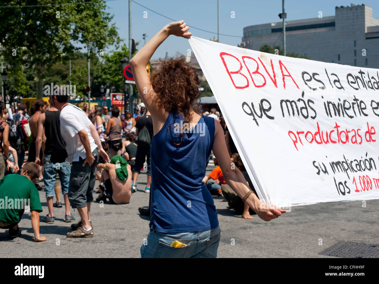A woman protester holds up a banner at an anti-government protests on Placa de Catalunya in Barcelona in May 2011 Stock Photo