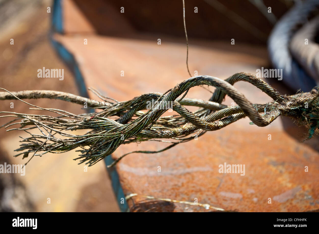 Close up of a corroded or broken steel; wire rope left in waste skips