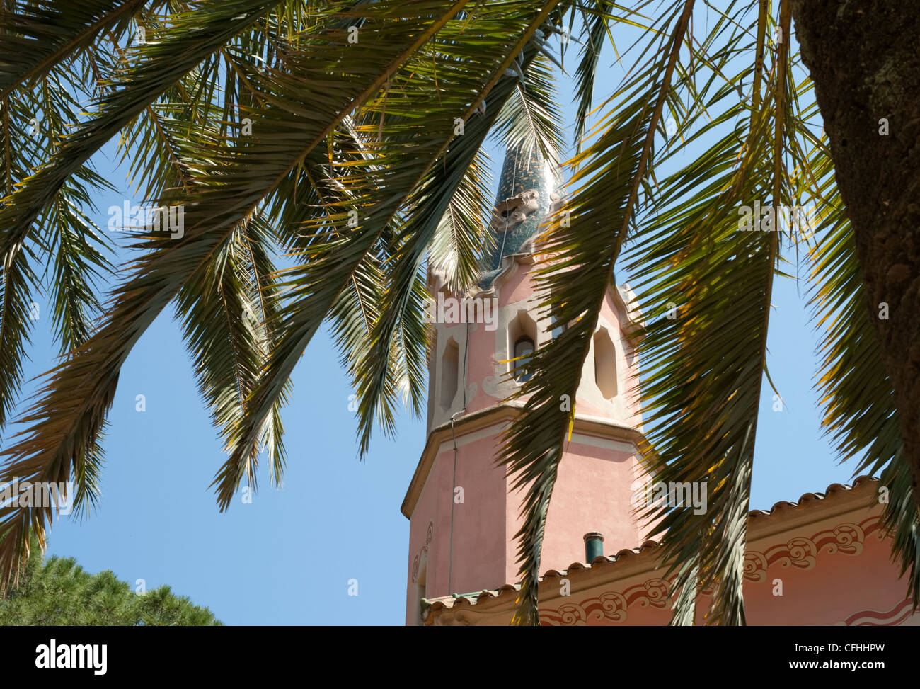 The Gaudi House Museum behind the leaves of a palm tree in Park Guell, Barcelona Stock Photo