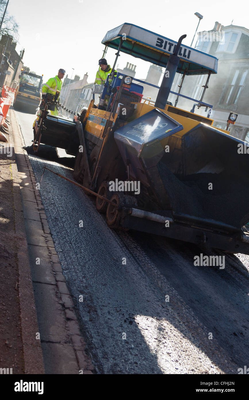 Tarmac asphalt being laid to resurface a road after road damage