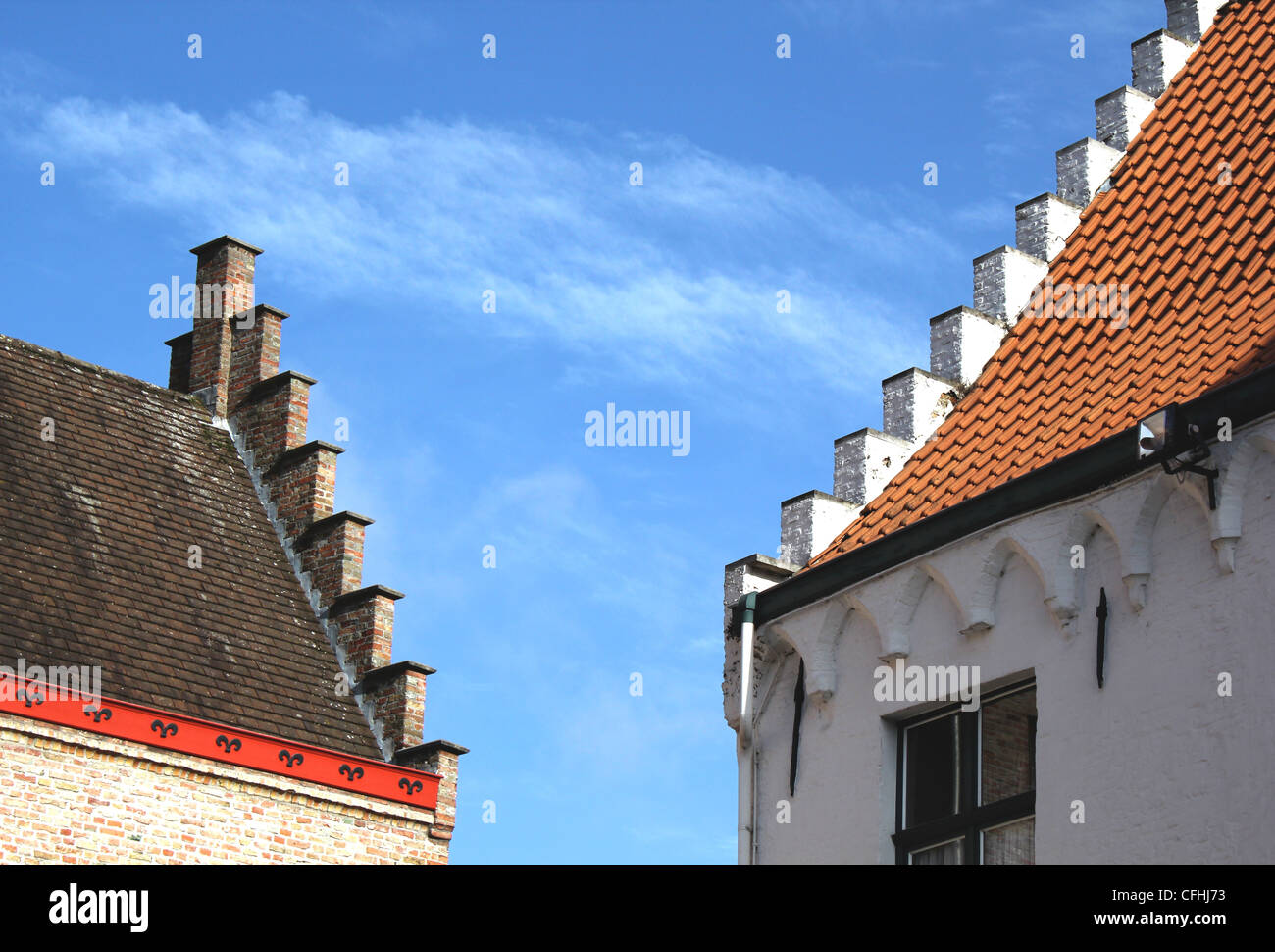 Two roof tops in Bruges with the characteristic stepped facade architectural detail Stock Photo
