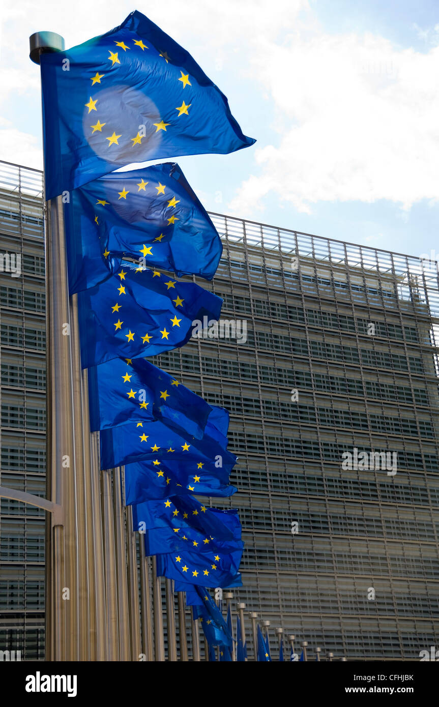 Vertical close up of many distinctive European Union flags at full mast outside the Berlaymont building in central Brussels, Belgium Stock Photo