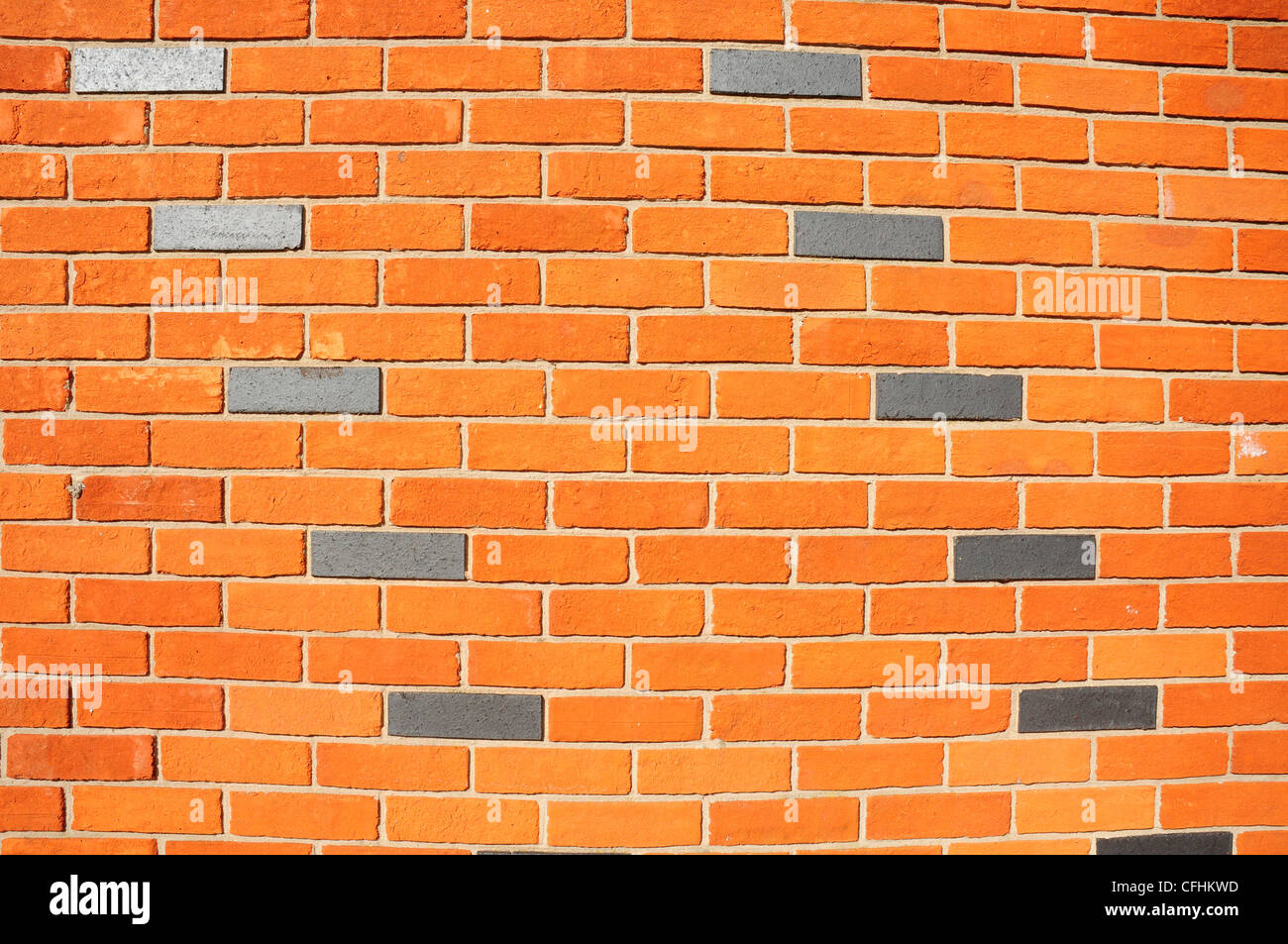 Cobalt bricks used to make a pattern in a curved brick wall. Chichester