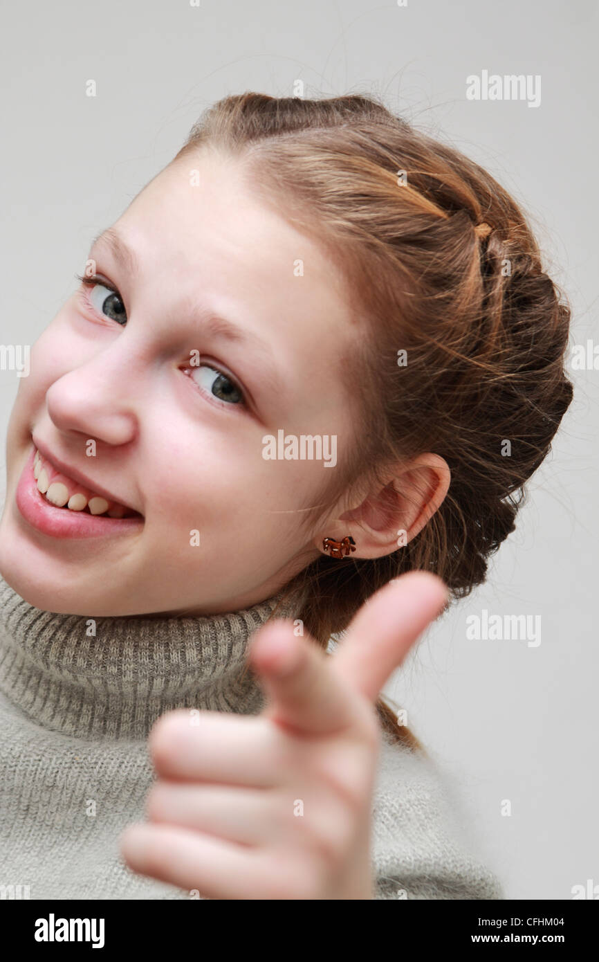 Funny girl shows a finger in the frame Stock Photo