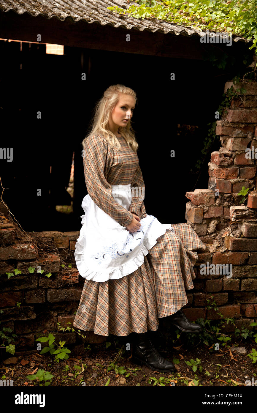 Blond girl in period servant dress Stock Photo