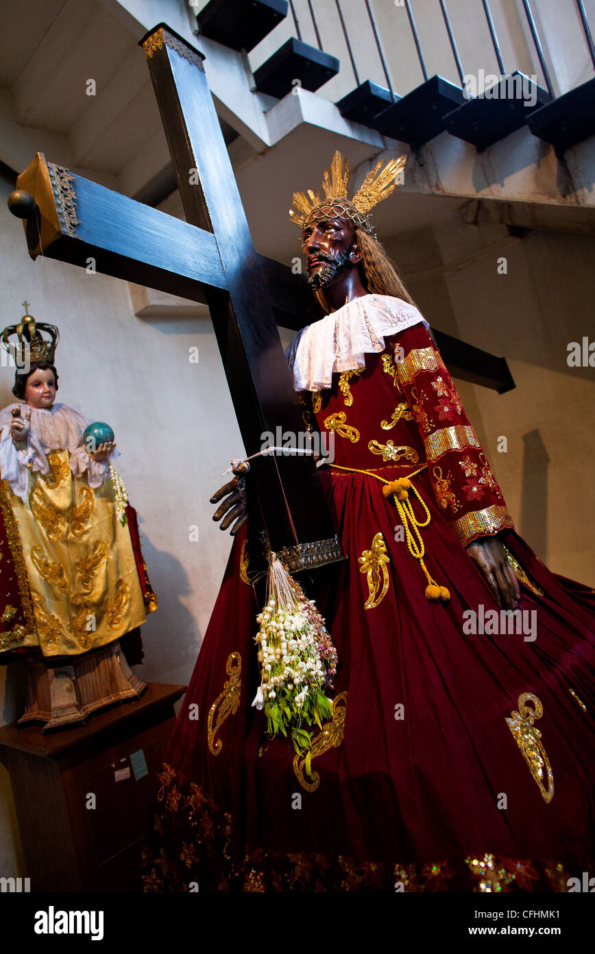 A statue of the Black Nazarene sits inside the Antipolo Cathedral in the Rizal Province of the exotic Philippine Islands. Stock Photo