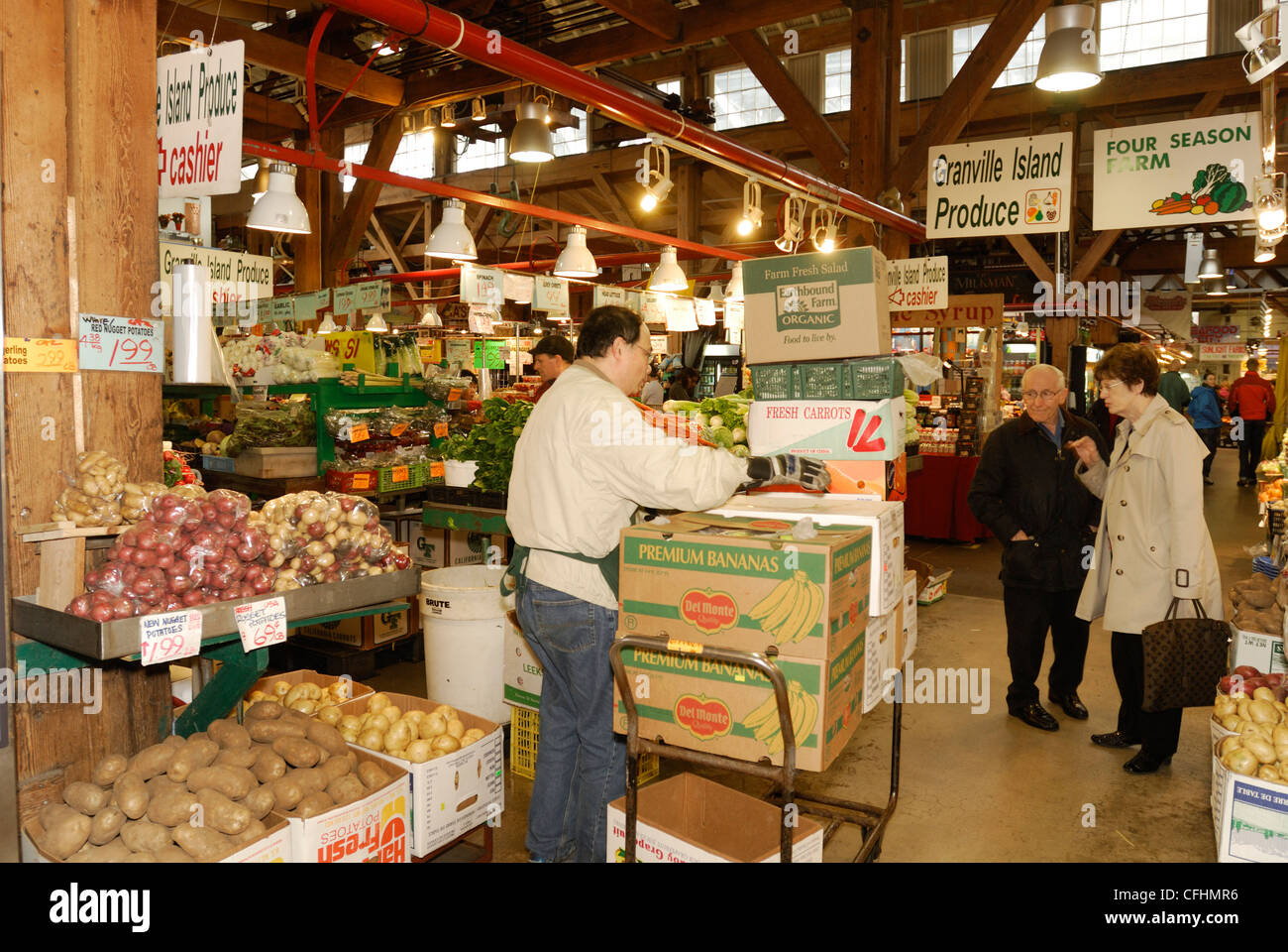 Produce retailer at Granville Island Farmers Market, Vancouver City, British Columbia.   i Stock Photo