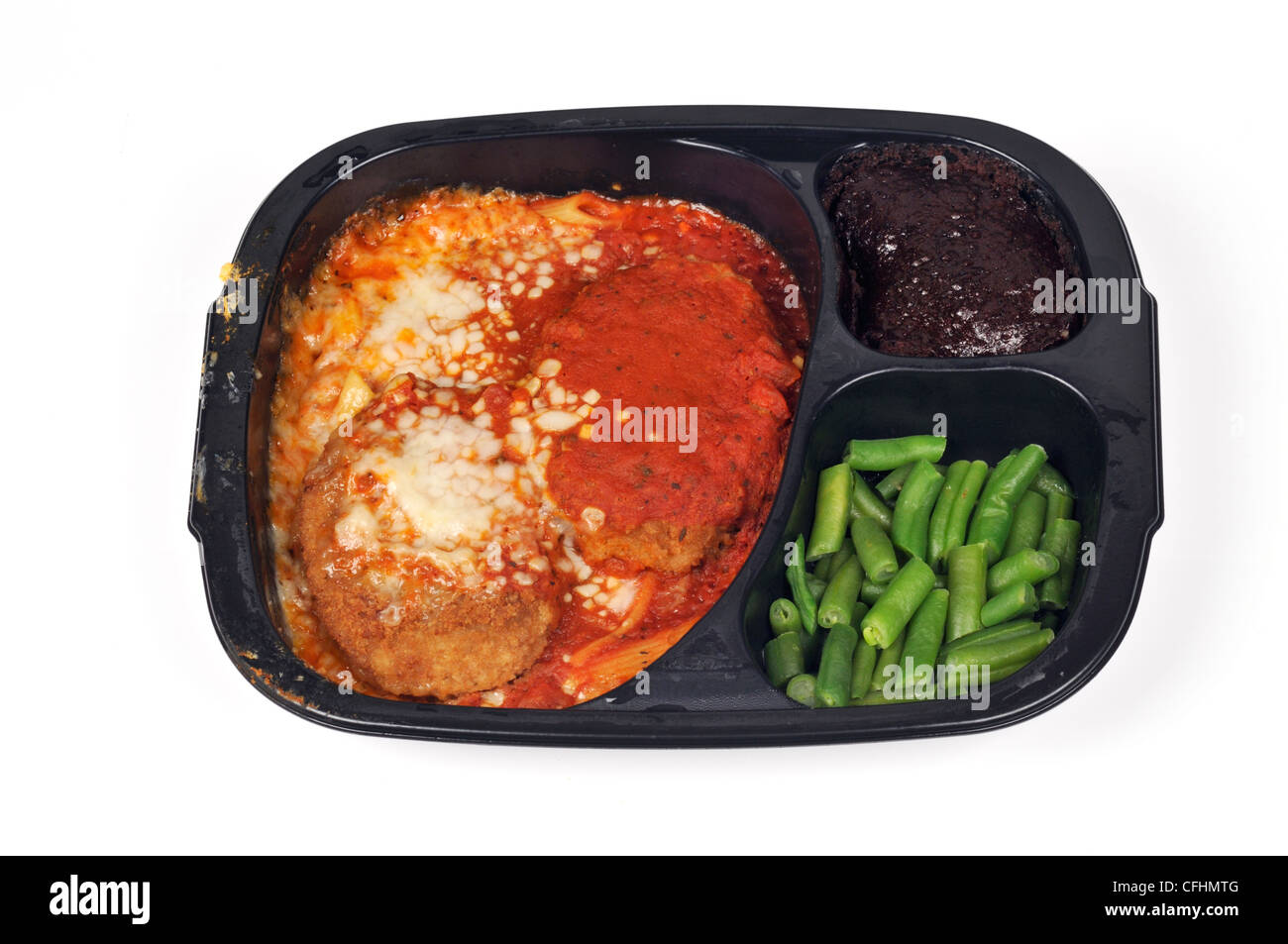 Cooked veal parmigiana readymeal tv dinner with green beans and brownie dessert in black plastic disposable tray USA Stock Photo