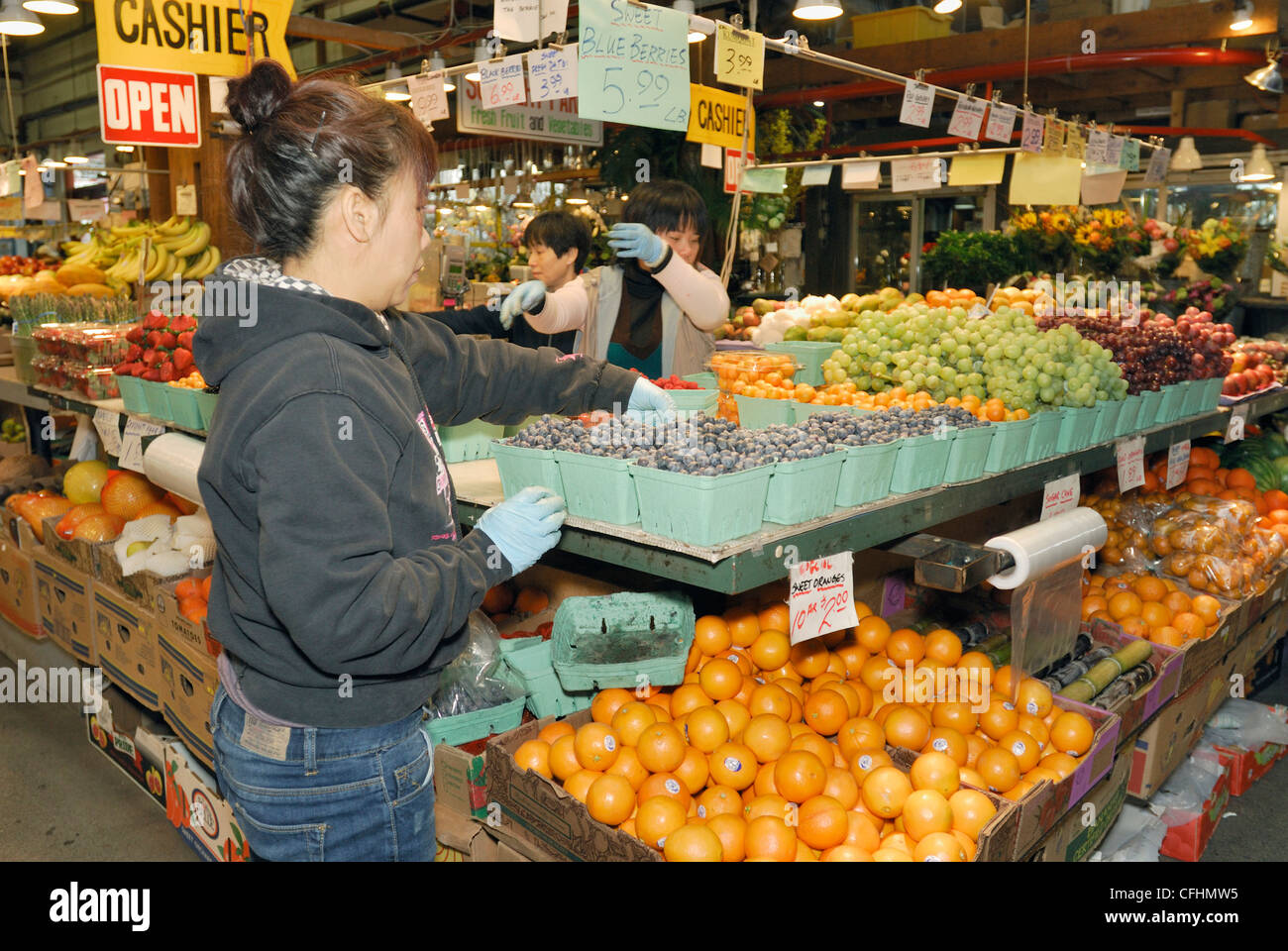 Fruit stand and vendors at Granville Island Farmers Market, Vancouver City, British Columbia. Stock Photo