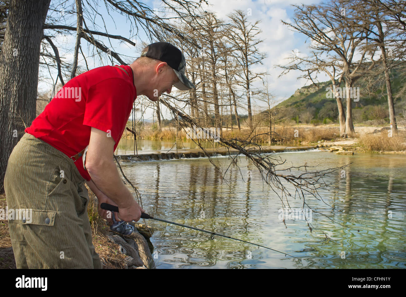Angler fishing with fishing rod at Frio River in Texas Stock Photo